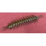 A small bronze figure of an articulated centipede.