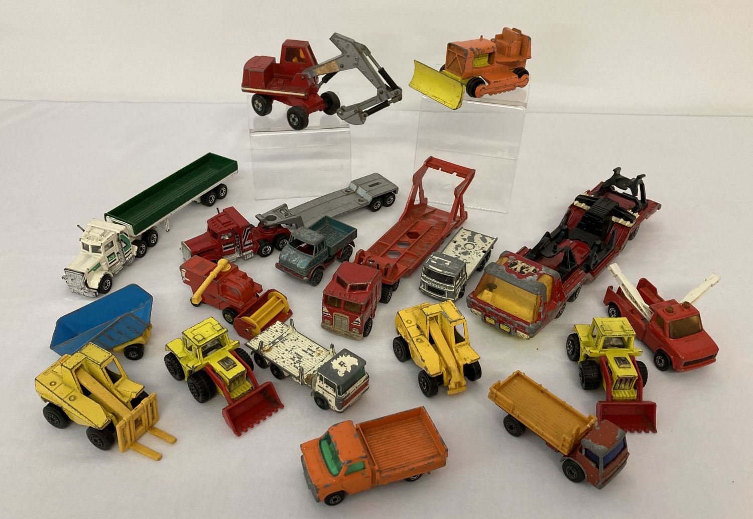 A collection of vintage toy lorries, construction and farm vehicles by Matchbox.