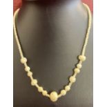 A vintage graduating carved bone bead necklace with screw clasp.