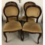 A set of 4 modern dark wood balloon back chairs with cabriole style front legs.
