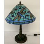 A tiffany style table lamp with leaded glass shade and lamp base.