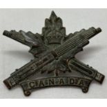 A WWI style Canadian Machine Gun Corps MGC cap badge.