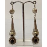 A pair of 925 silver drop earrings set with garnet cabochons.
