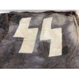 A German WWII style Waffen SS flag. Black ground with white SS marks.
