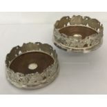2 heavy silver plated wooden based coasters with grape and vine detail to sides.
