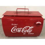 A vintage style painted metal Coca Cola cooler with lift off lid and bottle opener on front.