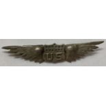 A WWI style silver US pilots wings badge. 'Made in Paris' impressed to reverse.