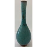 A Chinese porcelain bud vase with green speckled glaze.