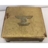 A German WWII style brass ornate Iron Cross box with spange and hammered effect details.