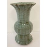 A pale green crackle glaze vase with scalloped rim.