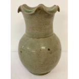 A green crackle glaze ceramic vase with a scalloped rim.