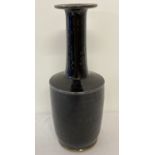 A long necked, black glazed ceramic vase with wide rim.