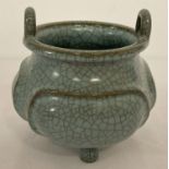 A blue/green crackle glaze ceramic censer, with loop handles and tripod feet.