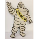 A painted cast iron "Michelin Man" wall hanging plague.