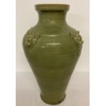 A very large celadon glaze vase of bulbous form, with animal head detail.