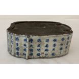 A blue and white Chinese porcelain ink stone with hand painted Chinese symbol decoration to sides.