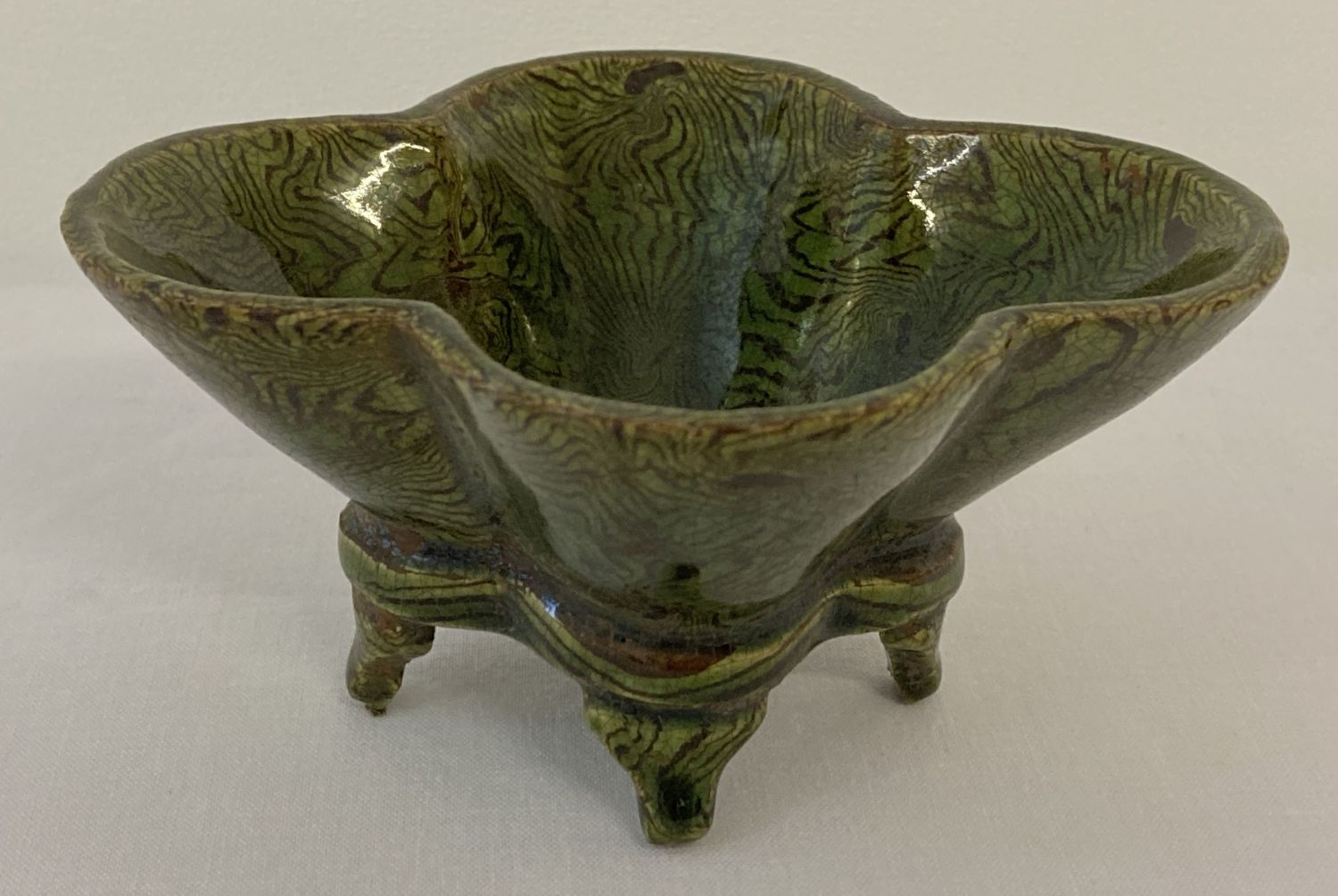 A small ceramic 4 footed quatrefoil shaped censer with unusual striped green glaze.