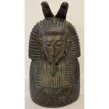 A carved wooden figure of an Egyptian Pharaoh. Painted black.