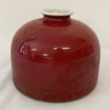 A Chinese red glazed beehive porcelain brush pot.