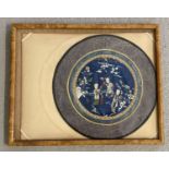 An embroidered silk roundel with figural detail, framed and glazed.