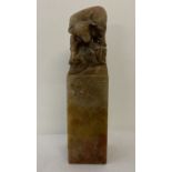 A square shaped soapstone seal with carved ox detail to top.