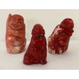3 small carved coral figures in the shape of Buddha.