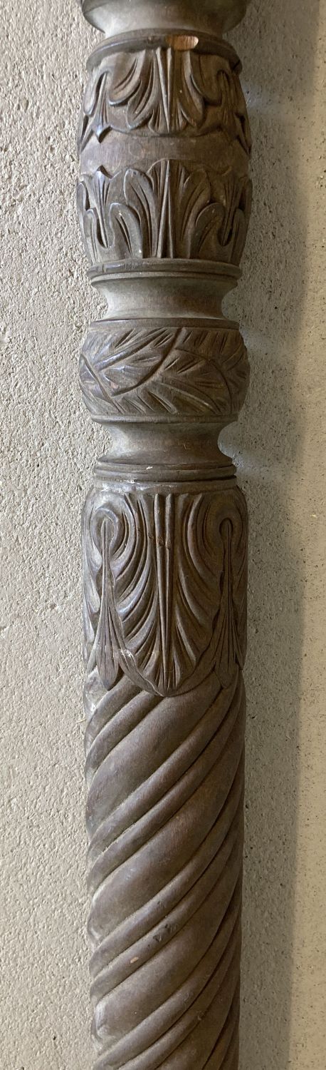 A large floral and spiral carved dark wood post with wooden wheel to bottom. - Image 2 of 2