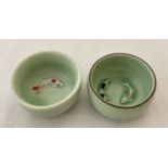 2 small ceramic Chinese bowls with fish detail to inner bowl, in pale green glaze.