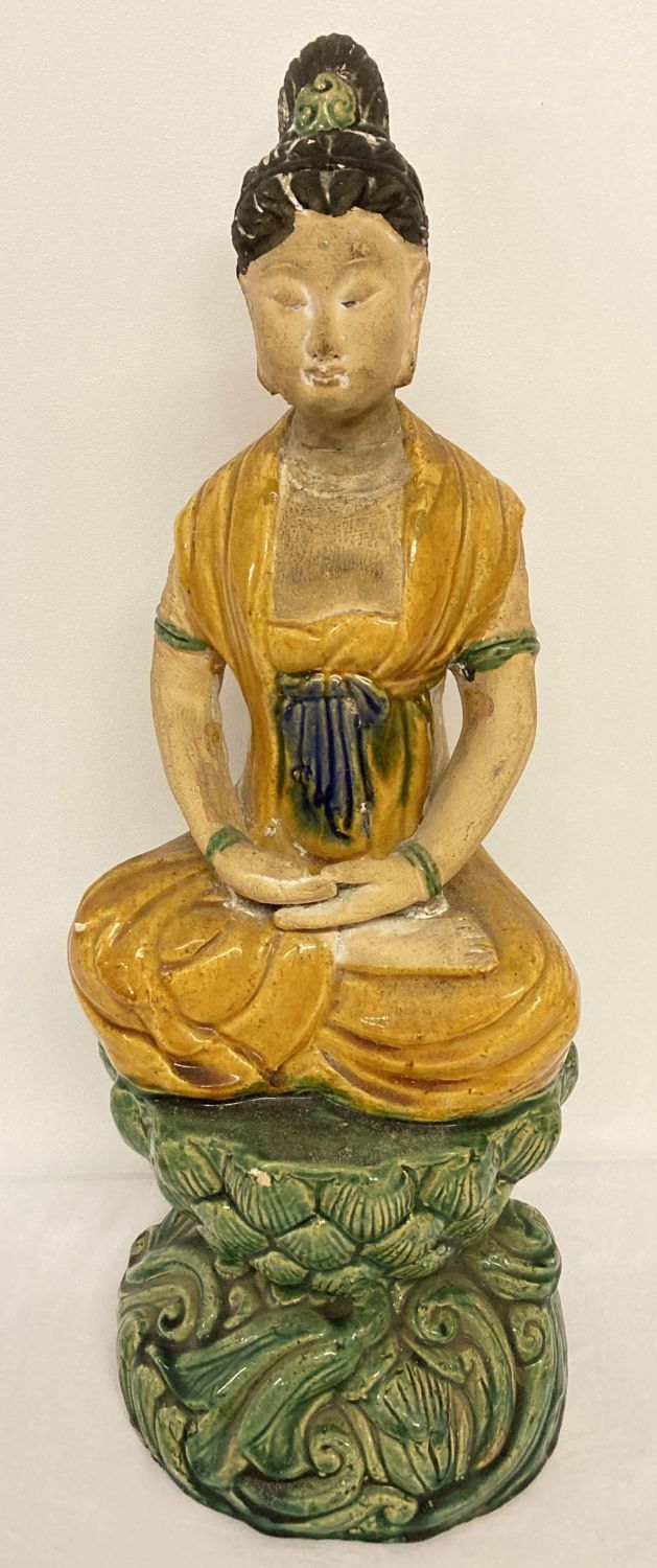 A large partly glazed Chinese stoneware ceramic figurine of a girl sitting atop a lotus flower.