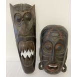 2 large African carved wooden masks.