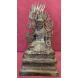 A square based hollow bronze figurine of an Oriental Deity with removable flame shaped back plate.