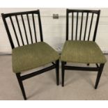 2 retro black painted wooden stick back style kitchen/dining chairs with green upholstery seats.