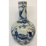 A very large ceramic, hand painted blue and white vase with figural and scenic design.