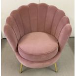 A new shell shaped retro style boudoir chair with dusky pink velvet upholstery.