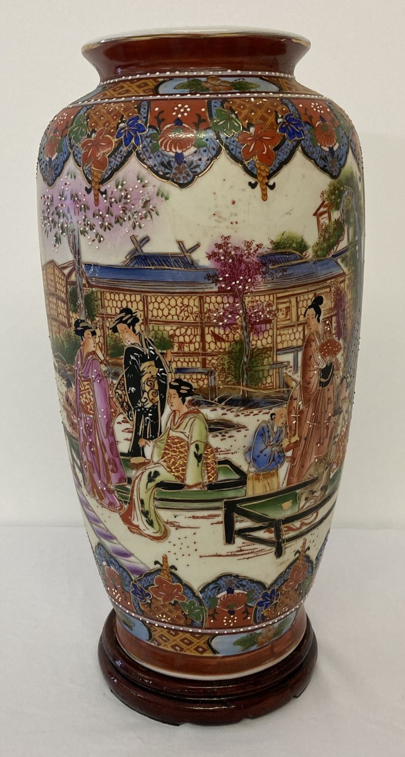 An oriental design ceramic vase depicting scenes of oriental ladies relaxing in a garden.