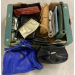 A box of assorted vintage handbags.