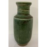 A dark green glazed ceramic vase with ridged neck.