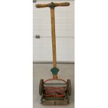 A vintage "The Britisher" hand push lawnmower by Shanks.