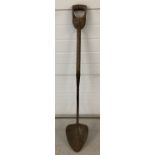 A vintage wooden handled turf spade.