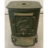 A green enamelled free standing wood burner by L. Lange & Co.