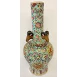 A very large ceramic long necked vase, decorated with peaches, birds and floral design.