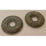 2 Chinese bronze roundels with central circular hole.