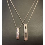 2 modern design silver necklaces. A fine curb chain with rectangular drop pendant set with a clear
