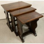 A vintage dark oak nest of 3 refectory style side tables.
