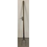 A vintage A & E Parkes & Co, Birmingham 8" pitch fork with original long wooden handle.