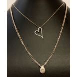 2 modern design silver necklaces. A curb chain with teardrop pendant set with a clear stone.