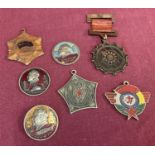 A collection of 7 vintage Chinese military medals and badges.