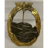 A WWII style Kriegsmarine E Boat badge with eagle and oak leaf surround.