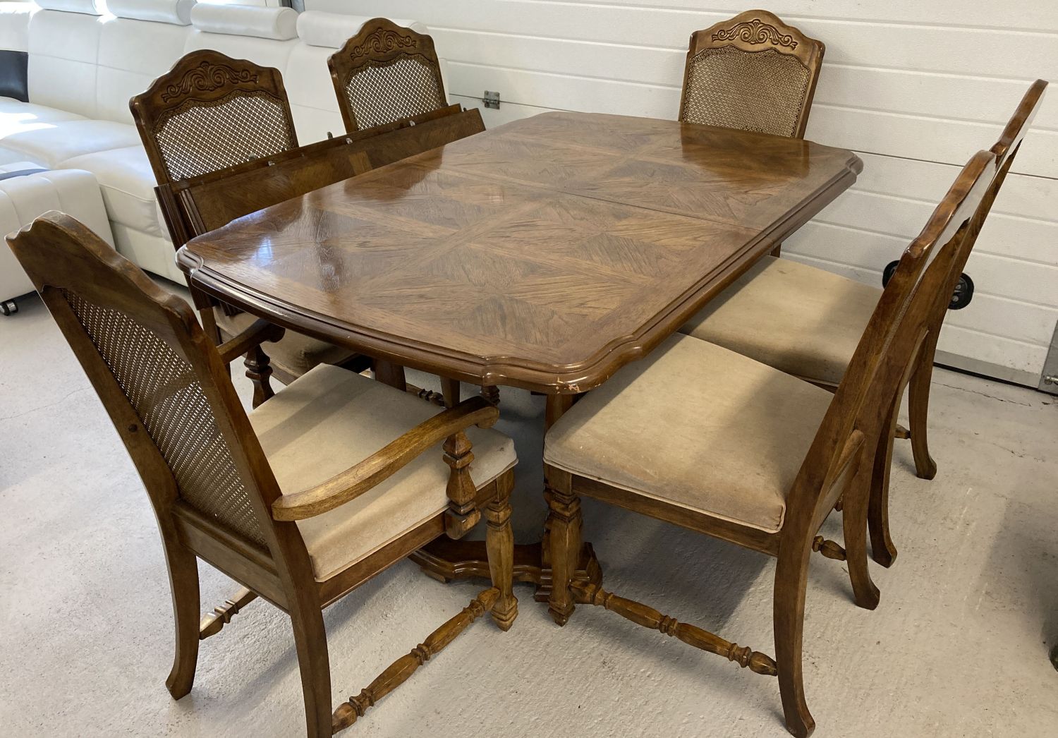 A solid wood dining room table with 4 matching dining chairs and 2 carvers.