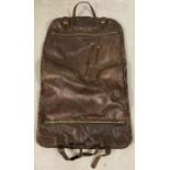 A brown leather suit carrier. Fully lined.